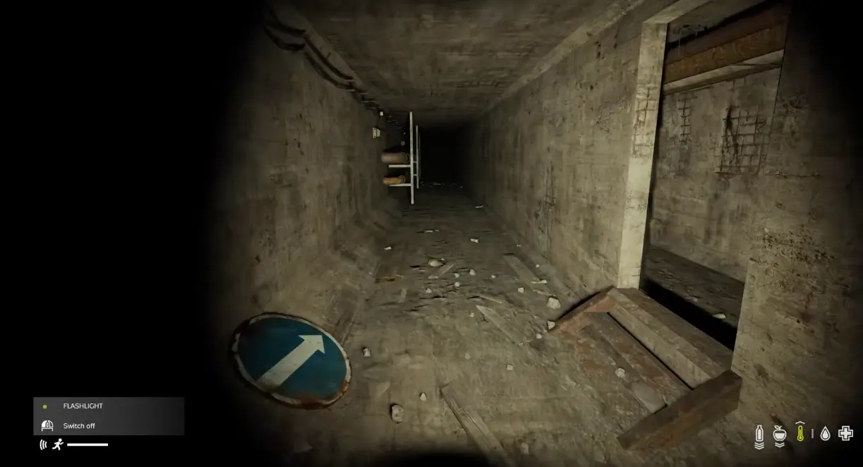 Blue directional marker beside a junction inside the contaminated Nasdara tunnel