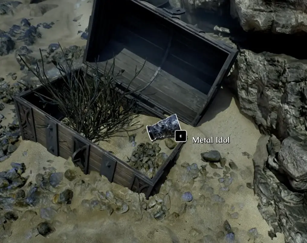 Metal Idol pickup near a chest in The Mound Omen of Cthulhu
